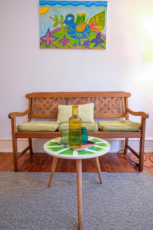 Colourful art and a comfortable bench in the guest house
